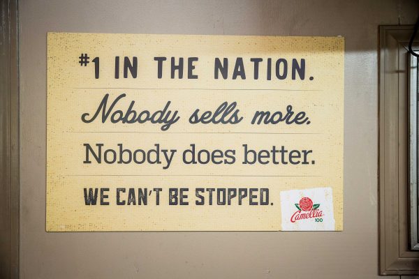 a painting saying "#1 in the nation nobody sells more nobody does better we cant be stopped"
