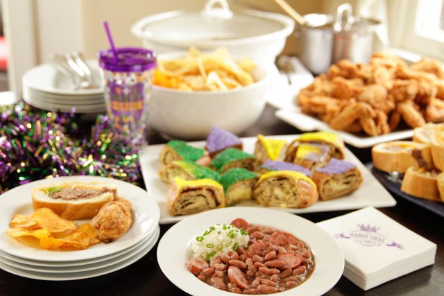 red beans and rice with a side of mashed potatos at a mardi gras party with king cake and bbq chips