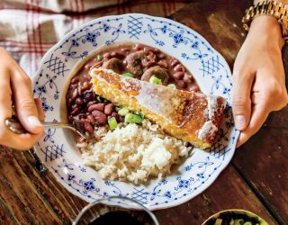 a plate of emily's red beans and rice with a side of corn bread