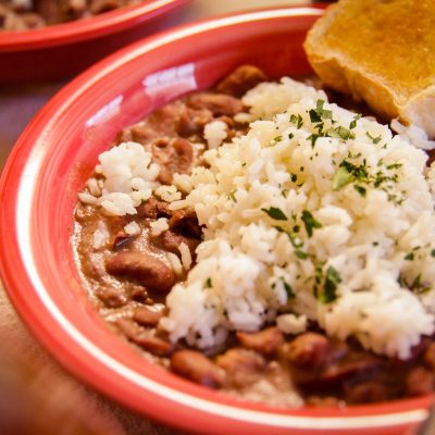 a plate of red beans and rice and a side of corn bread