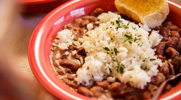 a plate of red beans and rice and a side of corn bread