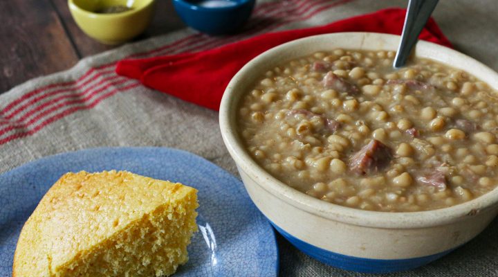 a bowl of lady cream peas with chisesi ham and a side of corn bread