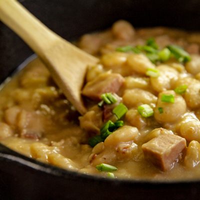 a cast iron dutch oven full of simple southern lima beans
