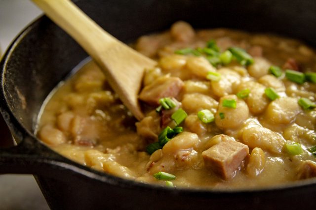 a cast iron dutch oven full of simple southern lima beans