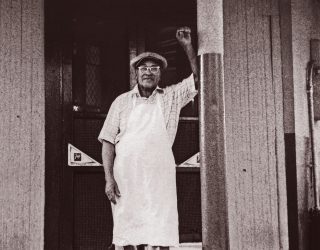 Buster Holmes in front of his restaurant