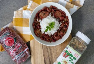 a bowl of red beans and rice next to a package of red beans and a container of zydeco chop chop seasoning