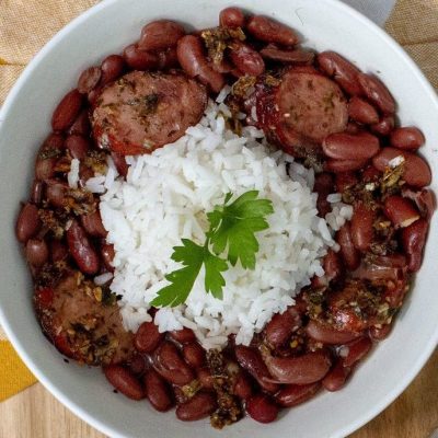 a close up of a bowl of red beans and rice cooked with zydeco chop chop seasoning