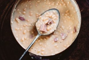 a pot of cajun white beans cooking in a pot