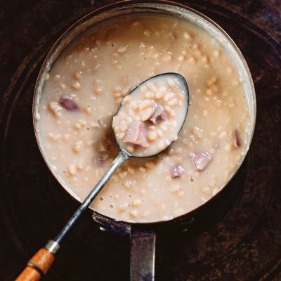 a pot of cajun white beans cooking in a pot