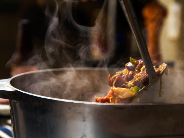 Photo of a serving spoon serving turkey bone gumbo by Chris Granger for Serious Eats