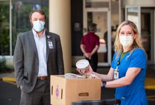 2 hospital workers recieving their donated red beans and rice