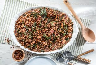 a big bowl of bourbon bacon field peas with collard greens