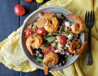 a close up of a bowl of garbanzo summer salad with shrimp and feta cheese