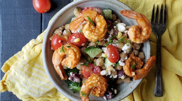 a close up of a bowl of garbanzo summer salad with shrimp and feta cheese