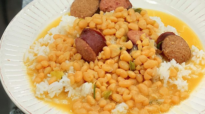 a plate full of Instant Pot Navy Beanswith rice and sausage