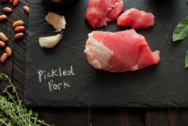 Pickled Pork on Black Cutting Board