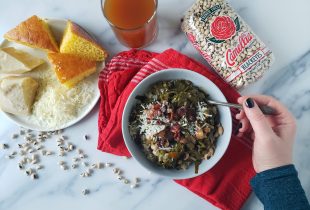 a bowl of Potlikker next to a package of camellia brand black eyes and a side of cornbread