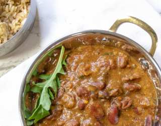 a bowl of red kidney rajma with an herb