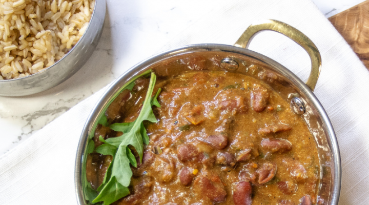 a bowl of red kidney rajma with an herb