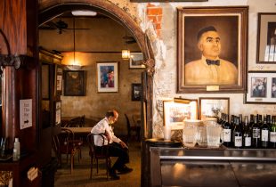 dining and bar area of napolean house showing a customer sitting in a chair