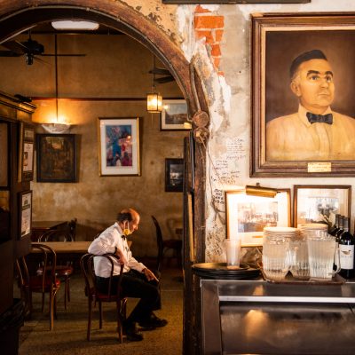 dining and bar area of napolean house showing a customer sitting in a chair