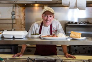 chef at fiorellas posing with his creations