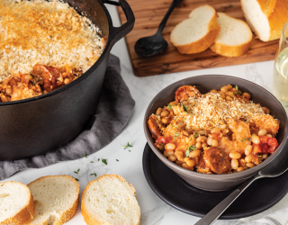 a bowl of Camellia's Shrimp, Andouille and White Bean Cassoulet next to a dutch oven