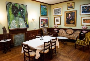 dining area in dooky chase's restaurant with art adorned on the walls and plenty of seating