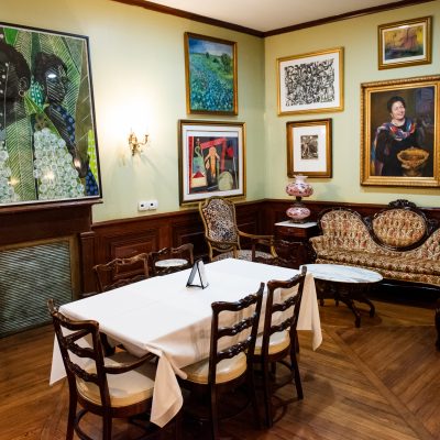 dining area in dooky chase's restaurant with art adorned on the walls and plenty of seating