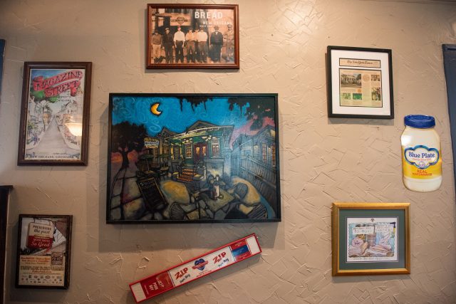 Pictures and art hanging on a wall inside of Mahony's.