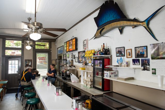 Inside Leni's restaurant decorated with pictures, newspaper articles and art