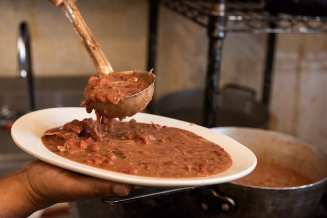 Scooping red beans onto a plate