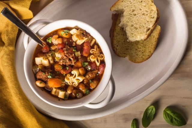 a bowl of kid friendly instant pot pasta fagioli with a side of bread