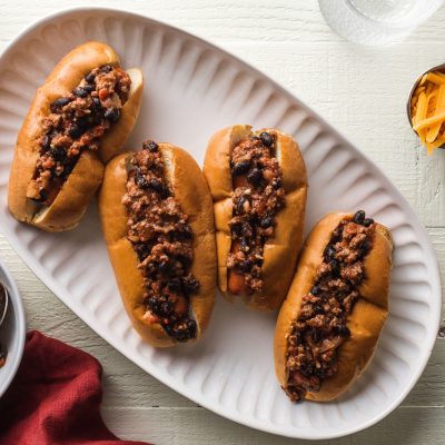 4 kid friendly sloppy joe hot dogs topped with ground beef and black beans on a plate