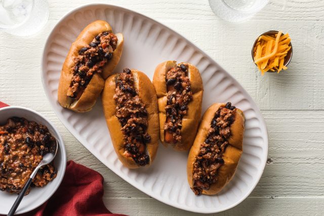 4 kid friendly sloppy joe hot dogs topped with ground beef and black beans on a plate