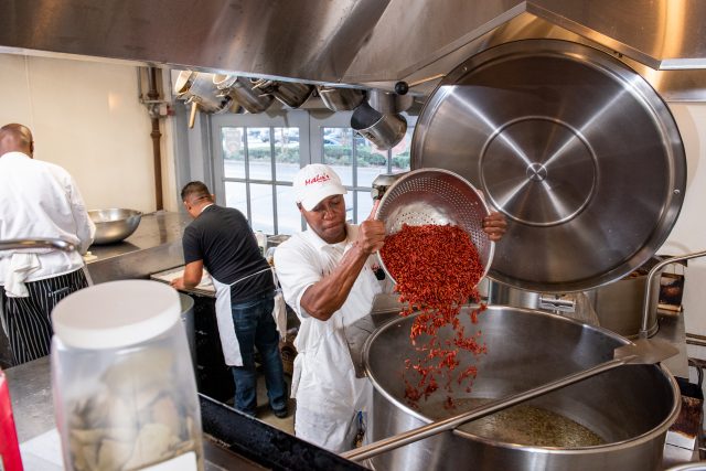 Pouring red beans into a giant pot