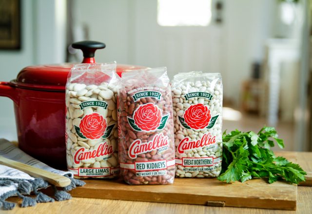 3 bags of camellia beans next to a dutch oven