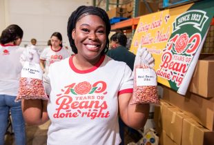 a person holding 2 bags of red beans