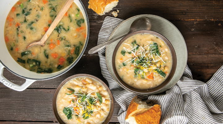 a top down view of creamy beans and collard greens soup