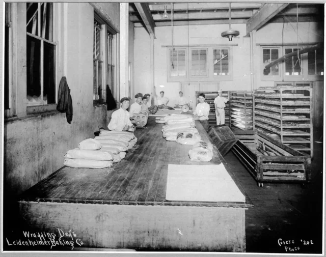 an old black and white picture of some workings making bread at leidenheimer baking co