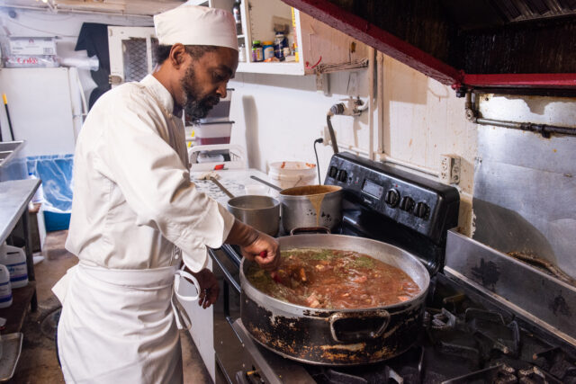 chef at heard dat resturant cooking a big pot of red beans