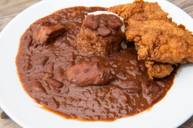 Bowl of red beans and rice with a side of fried chicken