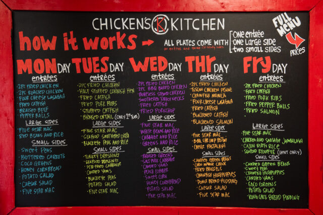 the colorful menu board for chicken's kitchen