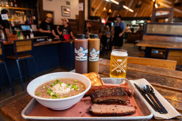 a close up of an order of red beans and rice with a few ribs at Blue Oak BBQ Restaurant