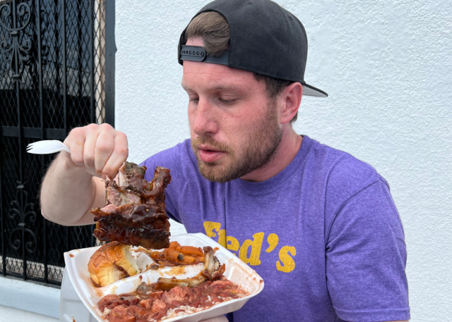 Devin Snow eating red beans and rice outside a local restaurant