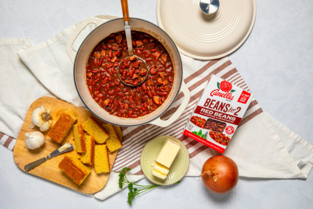 Box of red beans for 2 next to a pot of beans and cornbread and butter