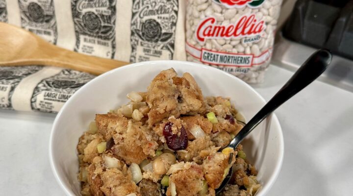 Sourdough Stuffing with White Beans in a white bowl on a table next to bag of beans