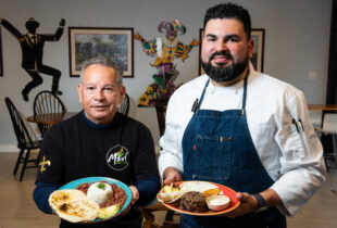 chef of mawi tortillas restaurant with bowls of completed dishes