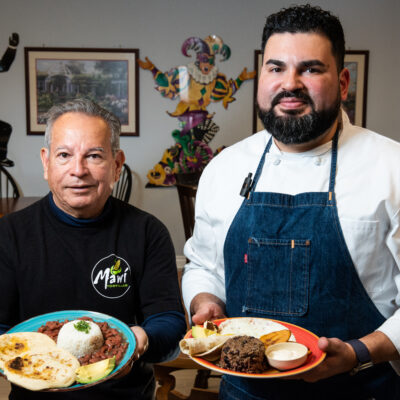 chef of mawi tortillas restaurant with bowls of completed dishes