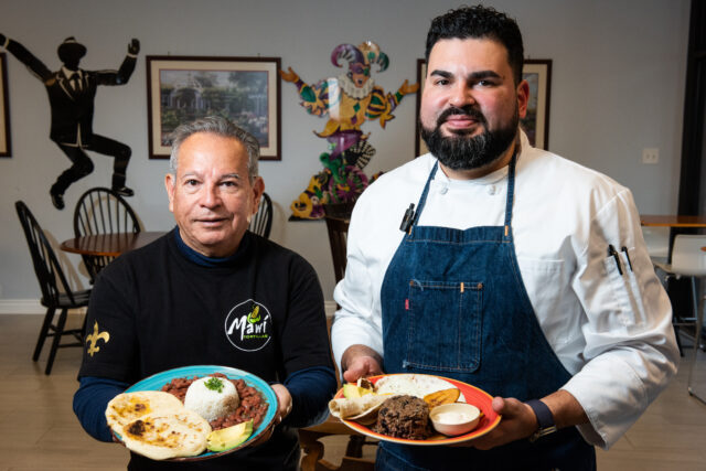 chef of mawi tortillas restaurant with bowls of completed dishes